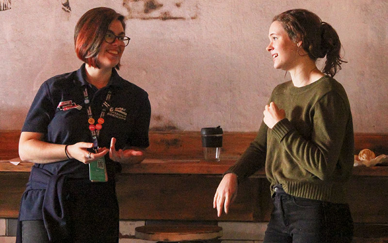 2 students talking at community breakfast