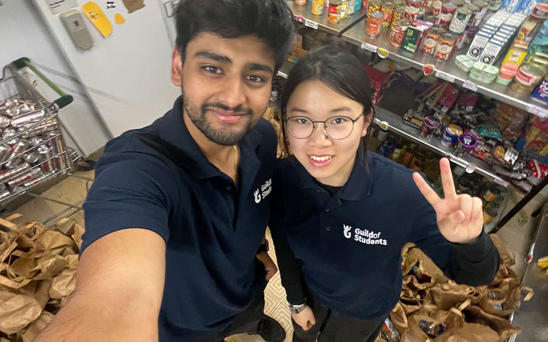 a photo of students surrounded by food in the pantry