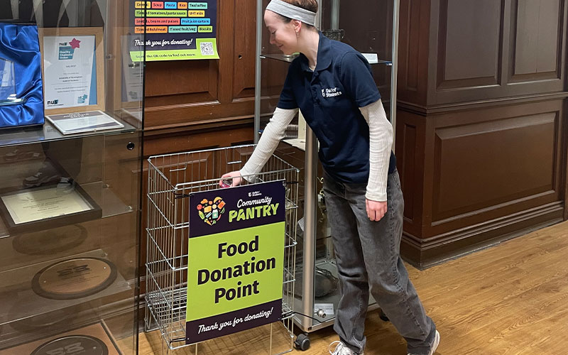 a photo of a student dropping off food in a drop off point